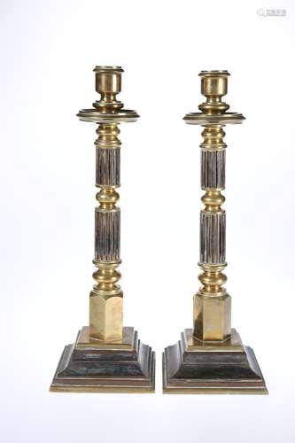 A SUBSTANTIAL PAIR OF BRONZE CANDLESTICKS