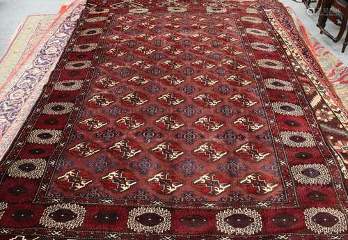 A TURKEMAN CARPET, the centre with a repeating design of fifty medallions