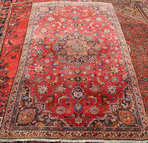 A MASHAD CARPET, with central medallion eight outer petals, on a red ground