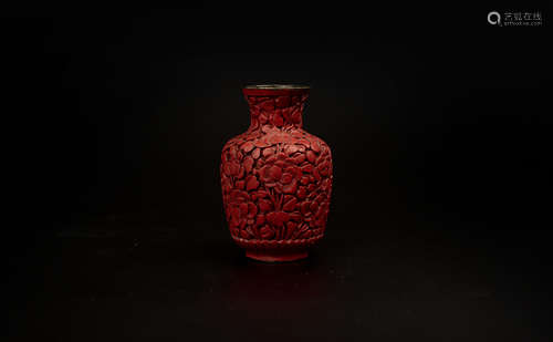 A SMALL CARVED RED LACQUER VASE