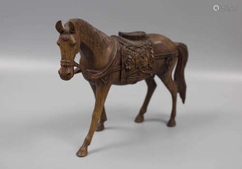 A WOODEN HORSE ORNAMENT