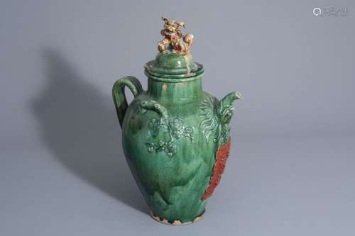 A large Chinese green glazed jug/jar with inscript...