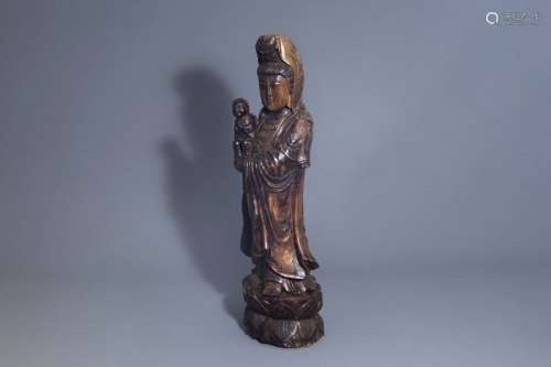 A large Chinese patinated wooden figure of Guanyin...