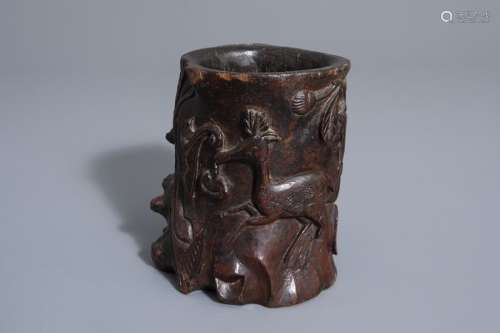A Chinese carved wooden brush pot with a deer, 19t...
