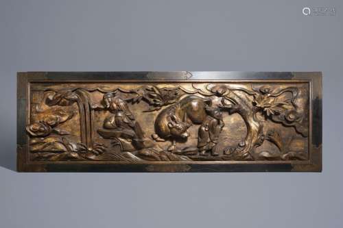 A large Chinese partly gilt carved wooden panel wi...