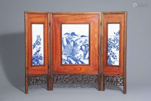 A Chinese threefold wooden screen with blue and wh...