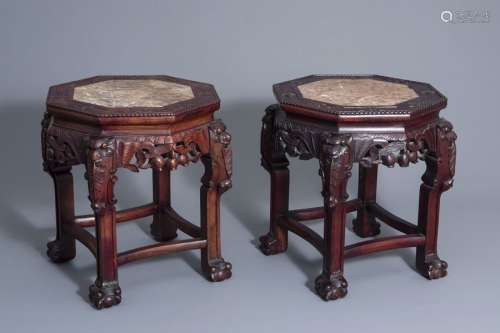 A pair of Chinese carved wood stands with marble t...