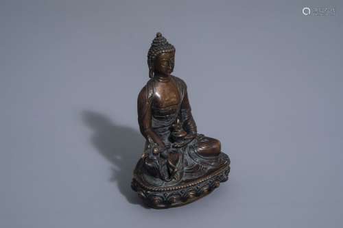 A Sino Tibetan bronze figure of a seated Buddha, 1...