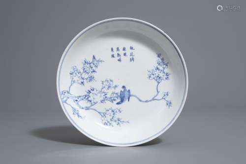 A Chinese blue and white plate with a bird on a br...