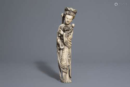 A Chinese ivory figure of a lady with flowers, sea...