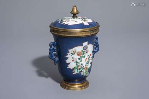 A Chinese famille verte powder blue ground cup and...