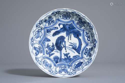 A Chinese blue and white dish with a deer in a lan...