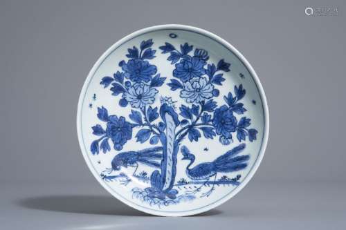 A Chinese blue and white dish with peacocks near b...