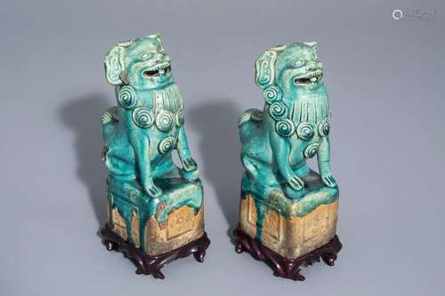 A pair of Chinese turquoise glazed models of Buddh...