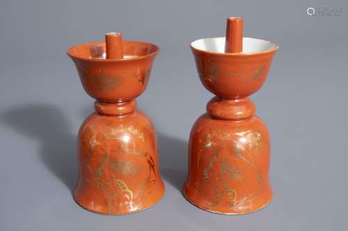 Two Chinese gilt decorated coral ground candlestic...
