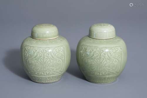 A pair of Chinese celadon jars and covers with und...