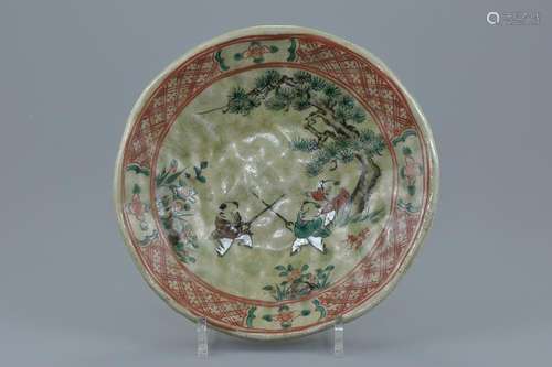 A Japanese celadon glazed pottery dish painted