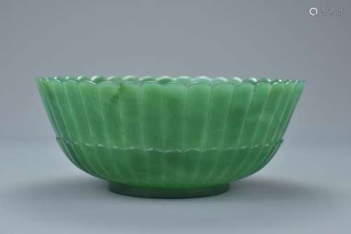 A Chinese jadeite bowl with fluted sides. 13Cm diam.