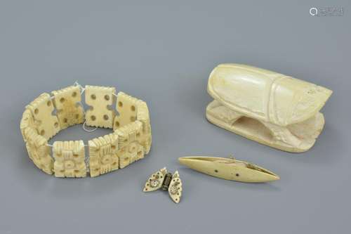 A carved ivory figure of a beetle together with a