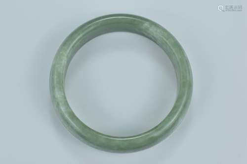 A Chinese jade bangle. Interior diameter 7cm