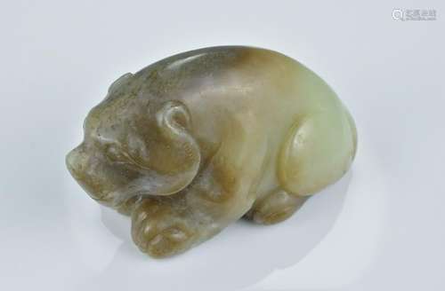 A Chinese pale green and brown jade carving of a seated