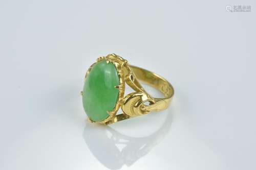 A Chinese high CT gold ring with jadeite cabochon.