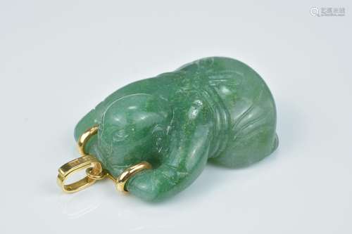 A vintage green jade pendant in the form of a Chinese