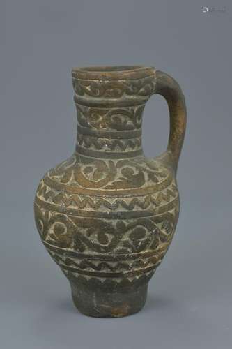 A Persian pottery jug and handle with pattern