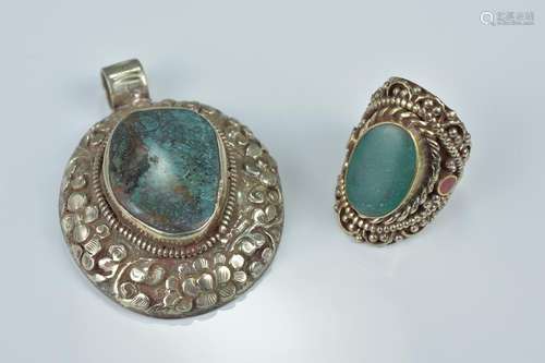 One Tibetan white metal pendant with large turquoise