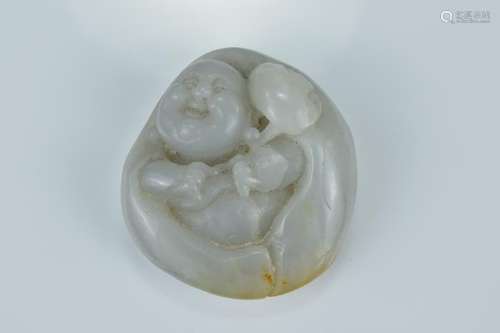 A Chinese carved jade pendant carved as a laughing