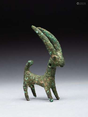 Figurine in the shape of an ibex with long horns. …