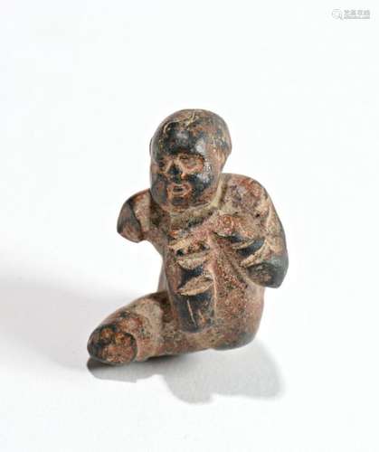 Figurine depicting a naked crouching baby. Figurin…