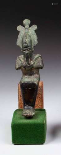 Statuette of Osiris seated, he is mummiform and ho…