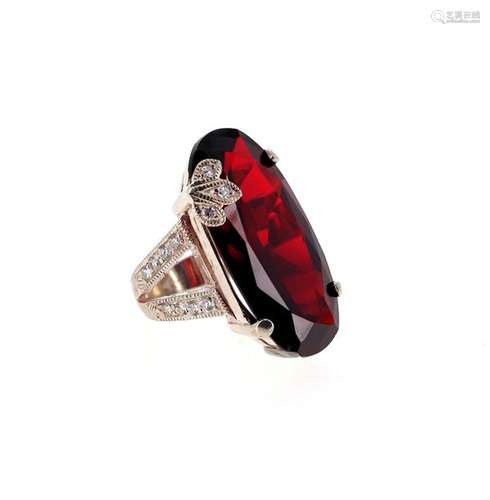 Silver plated metal ring set with a large oval red…