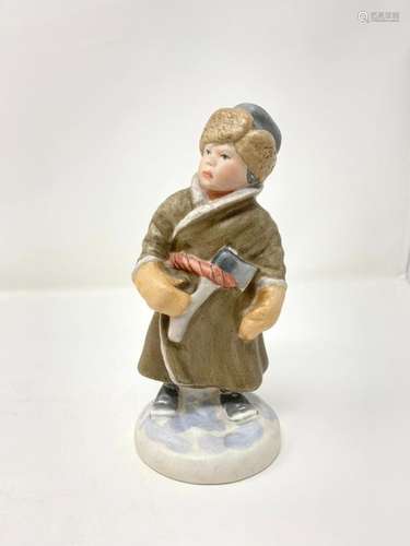 Bisque porcelain figurine of a young lumberjack. A…