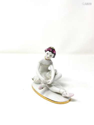 Polychrome porcelain figurine with gold highlights…