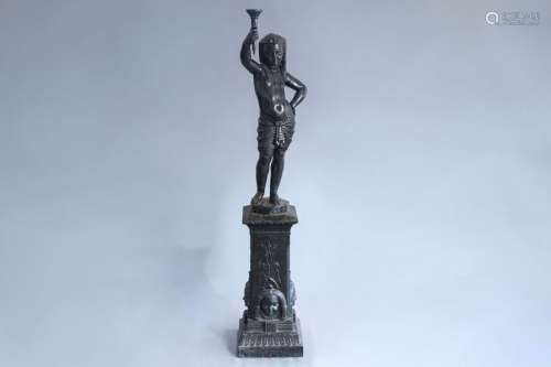 A black lacquered cast iron figure on a pedestal o...