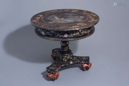 A round lacquered wood chinoiserie table with moth...