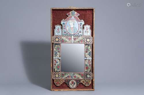 A mirror with reverse painted glass frame, Qajar, ...