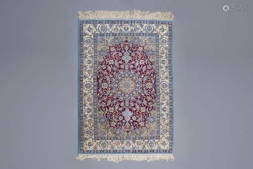 An Oriental rug with floral design, wool and silk ...