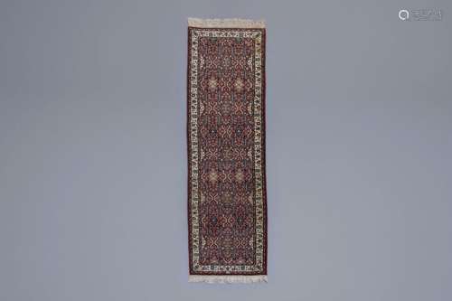 An Oriental runner with floral design, wool on cot...