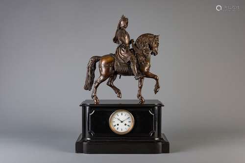 A black marble mantel clock with on top a patinate...