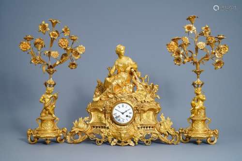 A French gilt bronze three piece clock garniture w...