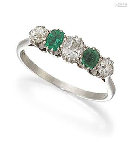A diamond and emerald five stone ring, of half-hoop design, the three graduated old-cut diamonds