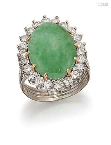 A jadeite jade and diamond cluster ring, the oval jade cabochon within a brilliant-cut diamond