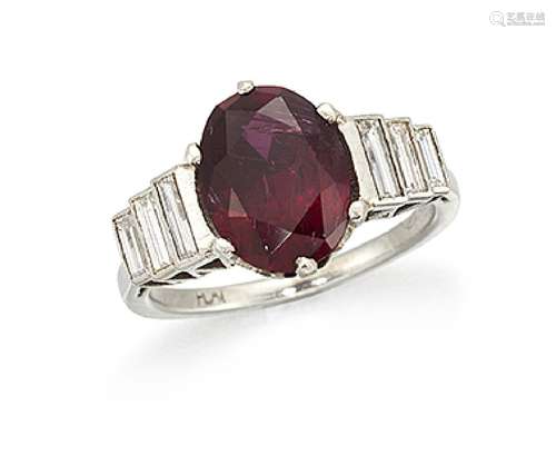 A platinum, ruby and diamond ring, the single claw-set oval-cut ruby with baguette diamond three