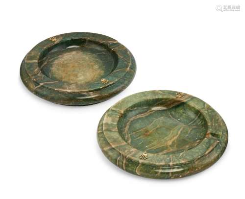 Two marble ash trays by Rolex, each of green stained marble and of circular form with applied