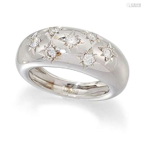 A diamond gypsy-set ring, the seven brilliant-cut diamonds in star mounts within a tapering hoop,