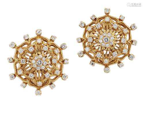 A pair of diamond-set earclips, of pierced stylised flowerhead design with brilliant-cut diamond