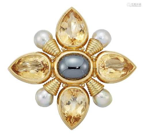 An 18ct gold and gem 'Kiss Pin' brooch by Elizabeth Gage, the central oval cabochon hematite
